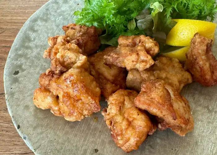A seasonal Japanese home cooking class in Kyoto, showing karaage fried chicken with a wedge of yuzu.